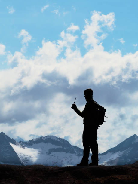 adventurous traveler ascends a snowy slope, framed by vibrant morning light and stunning cloud formations