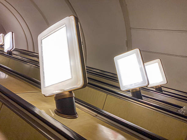 istock Image captures view from above of an ascending, empty escalator with a metallic finish Lighting casts shadows and highlights Slightly blurred effect 2204516731