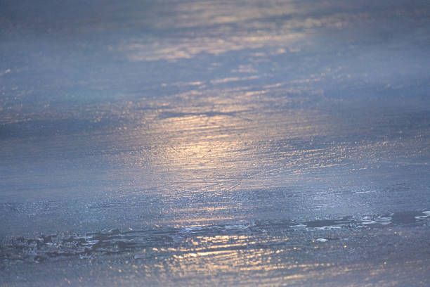 A beautiful, serene view of an icy surface that is reflecting soft light, which creates a calm and captivating visual atmosphere that evokes feelings of tranquility and peace in nature