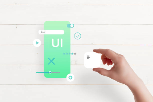 istock Top view of hand assembling app interface on table, placing text box, concept of UI/UX design and mobile app development 2204517499