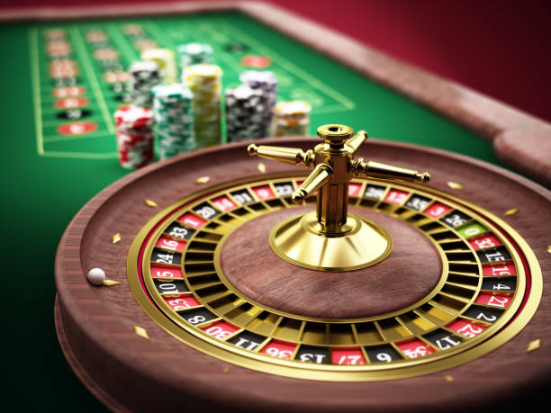 istock Roulette wheel with colorful chips on a plush casino table during an evening game 2204520218