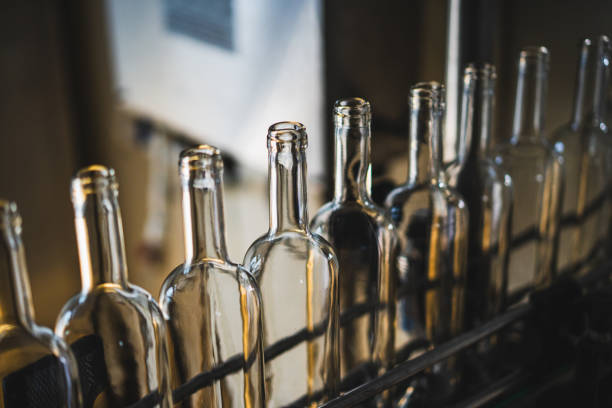 istock Line of empty glass bottles on a conveyor belt 2204520857