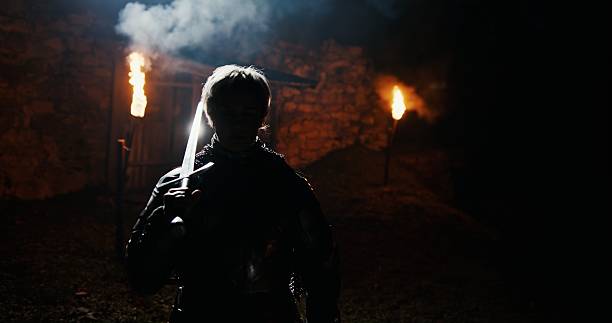 A Silent Vigilante Emerges from the Darkness, Surrounded by Engulfing Flames and Shadows