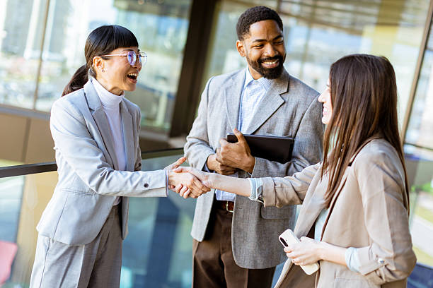 istock Business professionals engage in productive conversation at modern office setting in daylight 2204521280