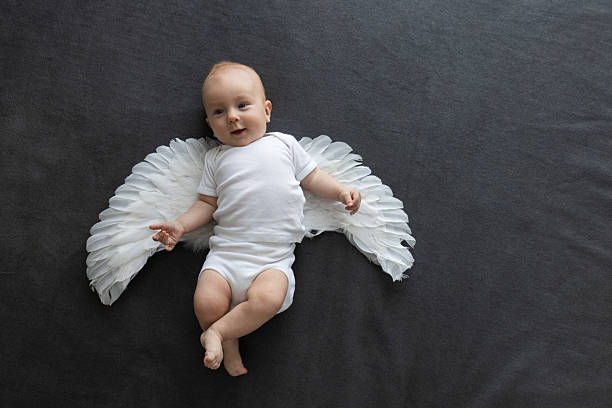 Smiling baby angel in a white clothes