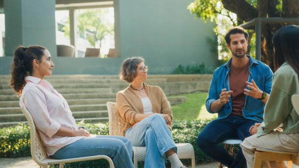 istock Diverse group people participating in outdoor community therapy session focused on mental health awareness and support sharing advice to promote empathy togetherness. Mental health concept. 2204522710