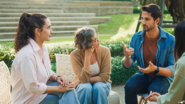 istock Diverse group people participating in outdoor community therapy session focused on mental health awareness and support sharing advice to promote empathy togetherness. Mental health concept. 2204522711