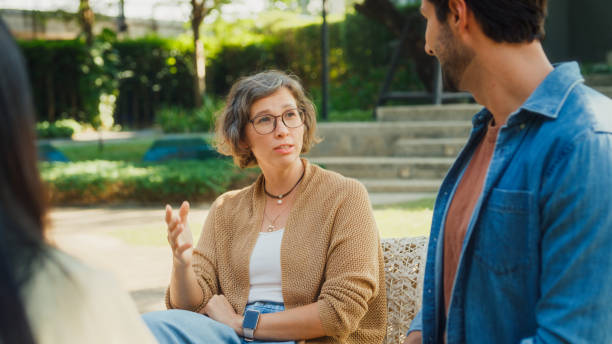 istock Diverse group people participating in outdoor community therapy session focused on mental health awareness and support sharing advice to promote empathy togetherness. Mental health concept. 2204522712