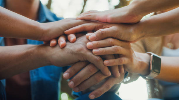 Closeup diverse group people engaging in supportive group therapy session, sharing personal stories and advice to promote mental health and recovery in park. Mental health community concept. Closeup diverse group of people engaging in supportive group therapy session, sharing personal stories and advice to promote mental health and recovery in park. Mental health community concept. woman comforting depressed friend stock pictures, royalty-free photos & images