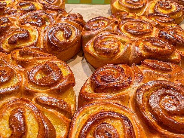 istock Freshly baked bread rolls with golden-brown, soft or fluffy interior Shaped in a swirl pattern on parchment paper Possibly taken in a bakery or home kitchen setting 2204522759