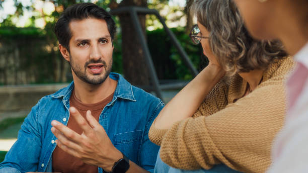 istock Diverse group people participating in outdoor community therapy session focused on mental health awareness and support sharing advice to promote empathy togetherness. Mental health concept. 2204522782