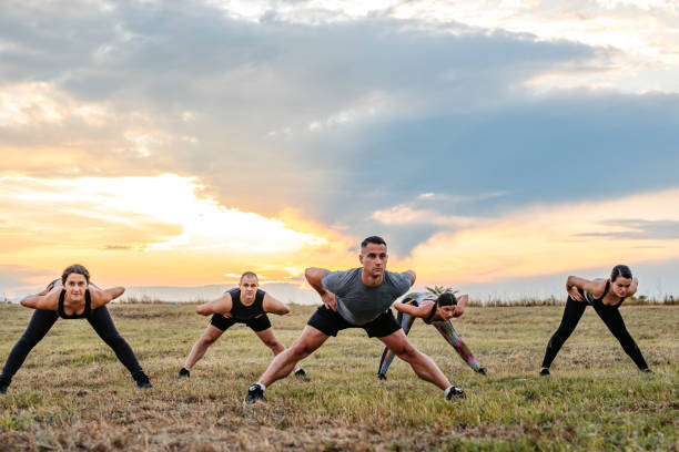 Young male friends doing push-ups in nature