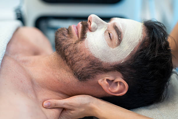 istock Man Relaxing with Facial Mask at Spa 2204528882