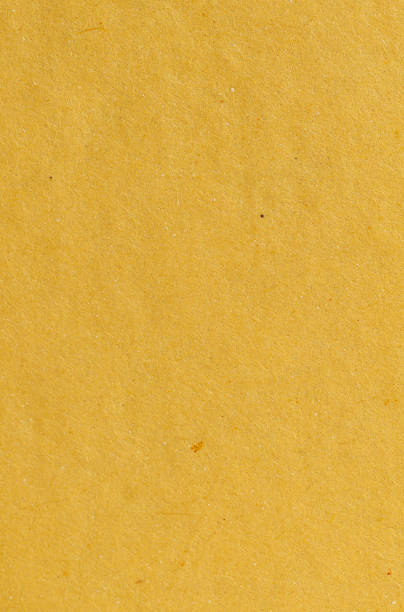 istock Close-up of textured yellow paper surface 2204529606