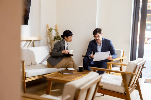 istock Business partners having a coffee and planning collaboration between their two companies 2204529873