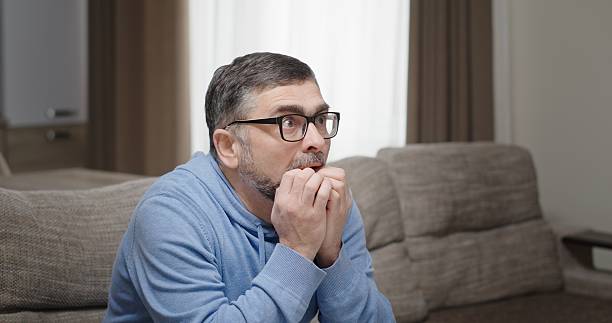 istock An Intense Emotion A Man Deeply Engaged in Watchful Anticipation With a Serious Expression 2204530732