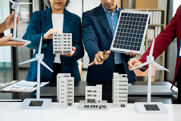istock Team of engineers in factory office, presentation on ESG project planning, solar panels, wind turbine power generation, sustainable energy efficiency. 2204532097