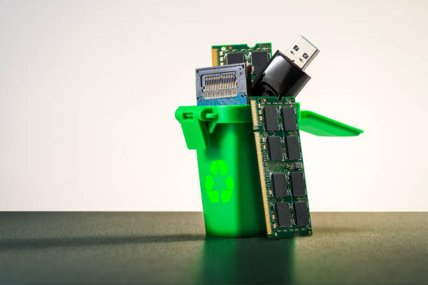 istock Green bin with circuit boards and electronic parts. Proper disposal of e-waste. 2204535272