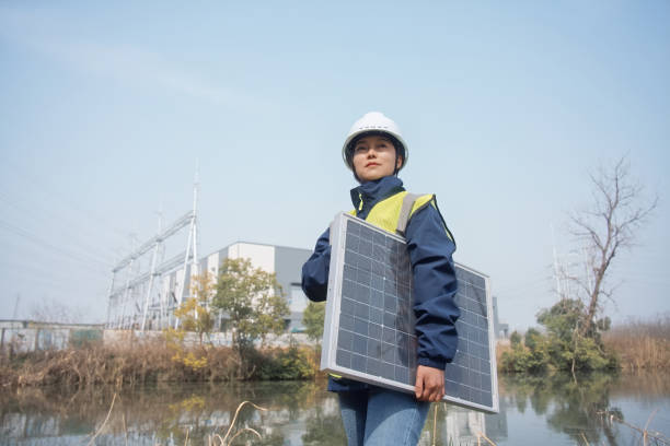 istock asian female engineer holding solar panel in power station 2204535533