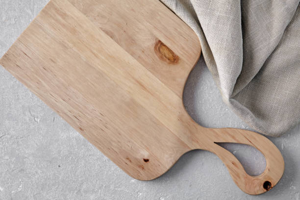 istock wooden cutting board and linen kitchen towel on grey kitchen table 2204537993
