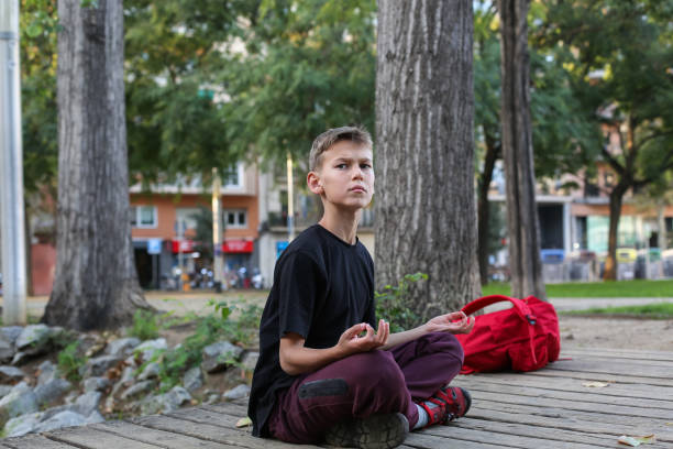 istock Handsome teenager doing exercises outdoors 2204542816