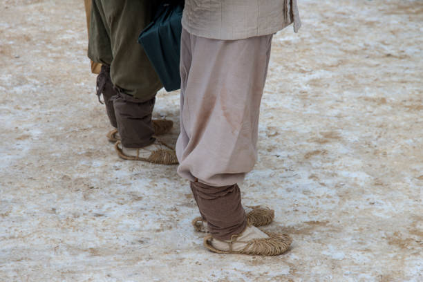 An ancient Roman man legs in caligae leather sandals. Reconstruction of the events of the Roman Empire