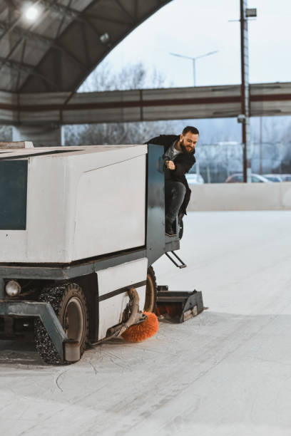 istock Positive Worker Maintaining Smooth Ice Surface at Indoor Rink 2204546523