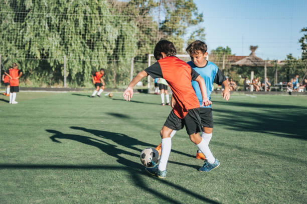 istock two boys fighting for soccer ball in match 2204546746