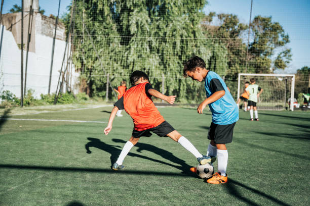 istock two boys fighting for soccer ball in match 2204546802