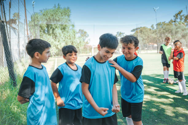 istock four soccer boys cheering after scoring a goal 2204546868