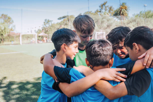 istock five soccer boys standing embraced together 2204546980