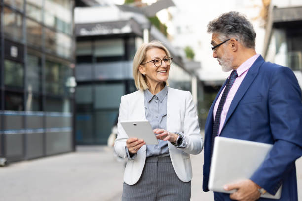 istock Smiling business partners discussing ideas in the city 2204549103