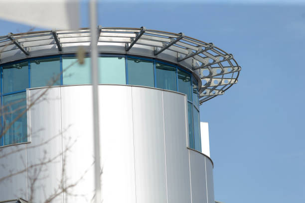 istock A tall commercial building stands against a blue sky backdrop 2204549435
