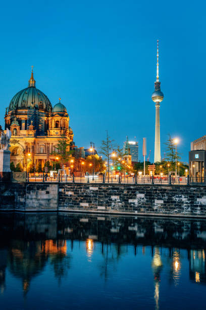 The Berlin Cathedral reflects in the Spree River at night as a tourist boat goes by. September 27, 2024.