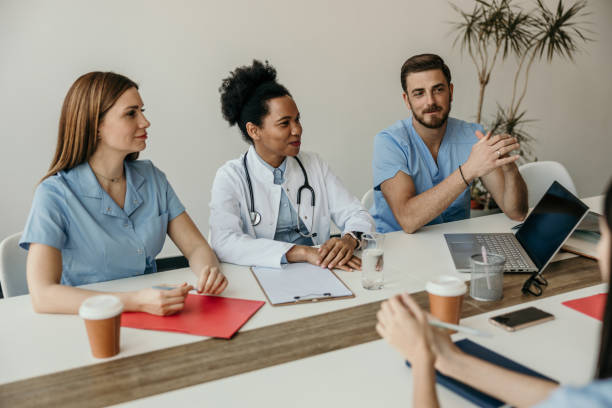 istock Group of hospital workers having a meeting 2204550009