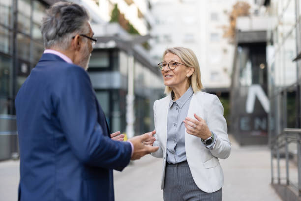 istock Animated conversation between joyful professionals outdoor 2204550132