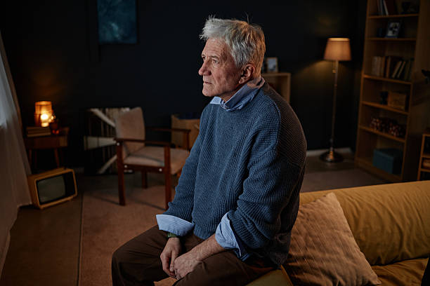 istock Sitting Elderly Man in Sweater Looking Thoughtful 2204551263