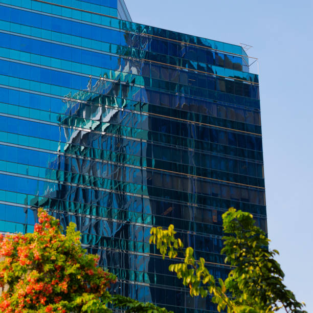 Low angle view of a modern office building with an overcast sky.