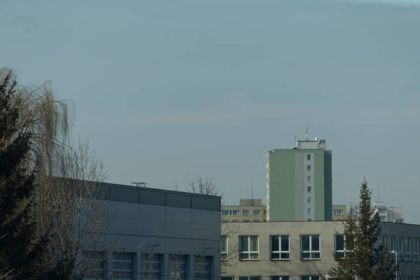 istock A big building with many windows is near trees and blue sky 2204553055