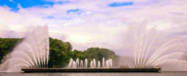 istock Dramatic water fountain display in a tranquil park setting on a sunny day 2204553209