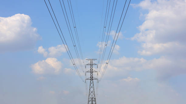 istock High voltage lamp post on a background of sky and clouds, Reinforced concrete pillar with high-voltage wires against a clear blue sky. Transmission of electricity by wires over long distances. 2204553419