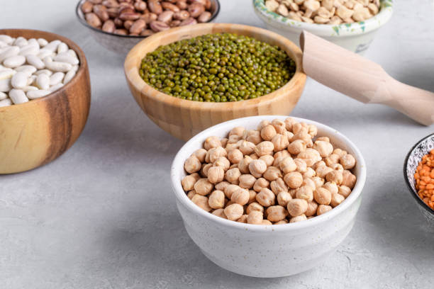 istock Dry legumes mix, plant-based protein sources in the bowls on gray table 2204553554