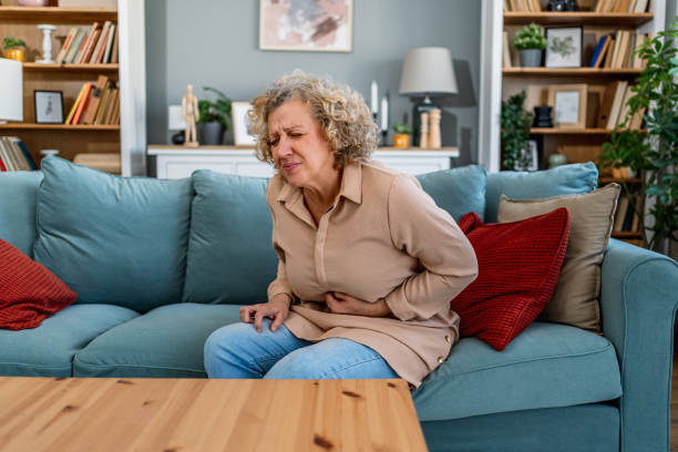 istock Woman suffering from stomach cramps 2204553558