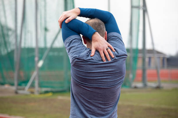 istock Mature male athlete doing a stretch exercise viewed from behind 2204553951