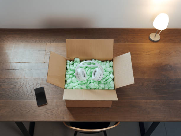 Headphones inside a delivery box on a desk