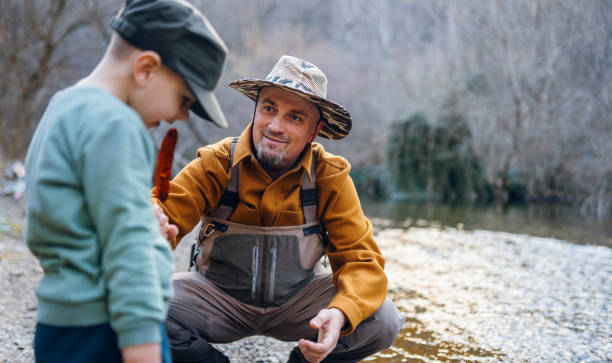 istock Fisherman with his grandson 2204556373