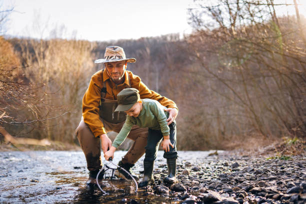 Grandfather and Grandson Fishing by the river