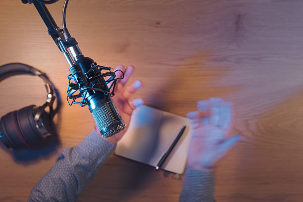 istock Content creator livestreaming a podcast in the studio 2204556720