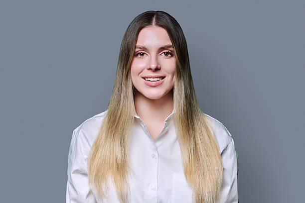 istock Headshot portrait young smiling woman on grey studio background 2204558434