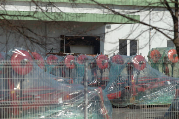 istock Numerous vehicles are securely wrapped in plastic behind a tall fence 2204559287